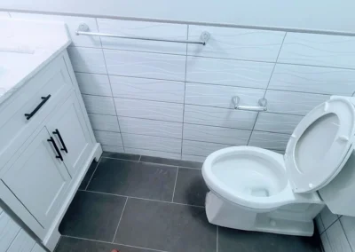 white subway tile installed half wall around bathroom