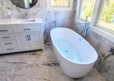 Bathroom built in large tile format main floor outside shower walls and inside shower walls