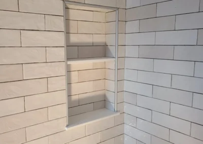 shower install in subway tile with a box insert for shampoo